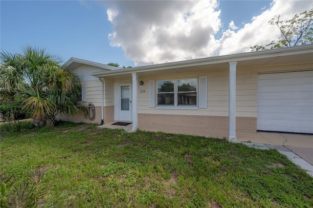 single story home with a garage and a front yard