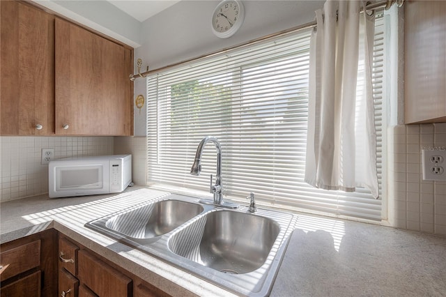 kitchen featuring sink and decorative backsplash