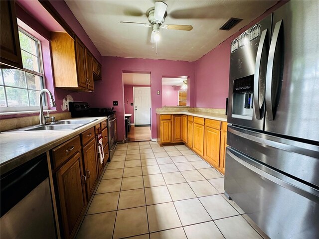 kitchen featuring sink, stainless steel appliances, ceiling fan, and light tile patterned floors