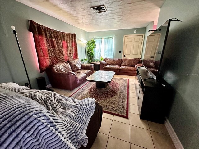 living room with light tile patterned floors and a textured ceiling