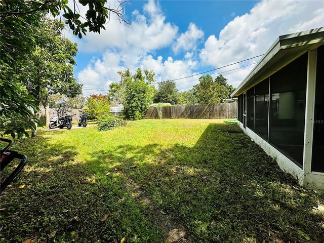 view of yard with a sunroom