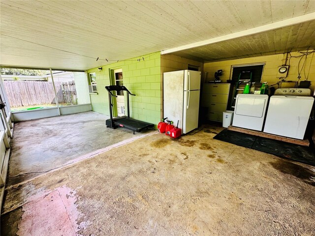 garage with washer and dryer and white refrigerator