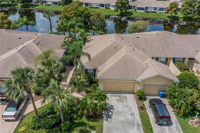 birds eye view of property with a water view and a residential view