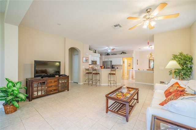 living room with light tile patterned floors and ceiling fan