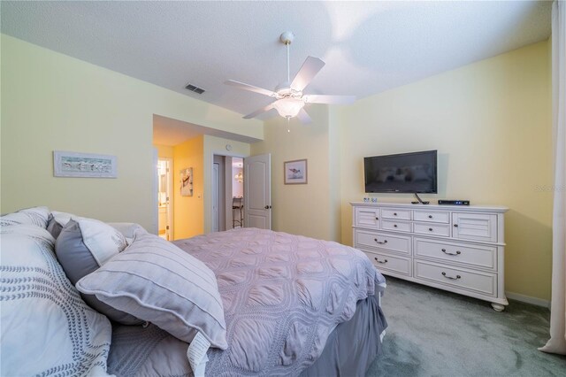 carpeted bedroom featuring connected bathroom and ceiling fan