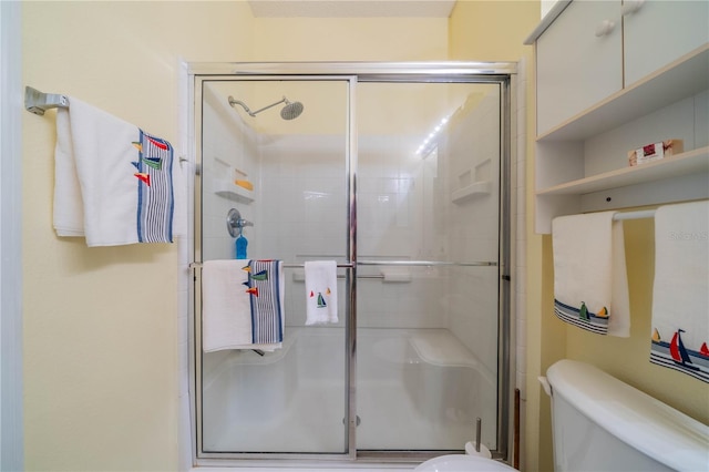 full bath with a shower stall and toilet