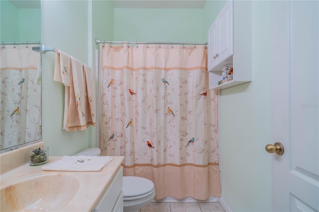 bathroom featuring tile patterned floors, vanity, and toilet