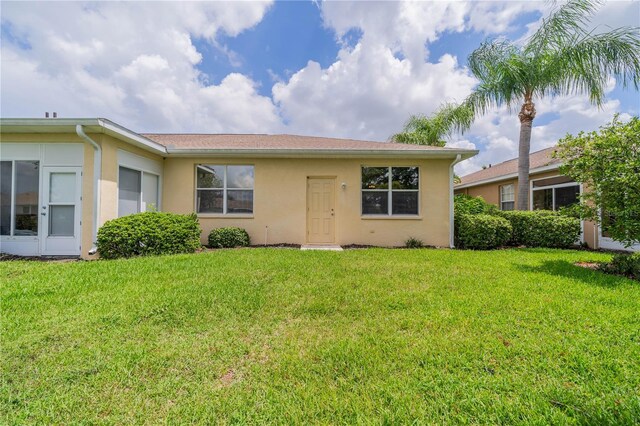 ranch-style home with a front lawn