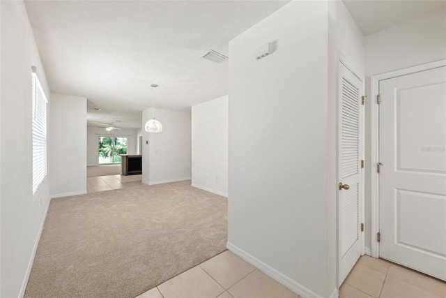 unfurnished living room with ceiling fan and light colored carpet