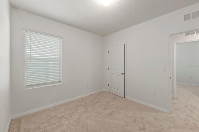 unfurnished bedroom with light colored carpet