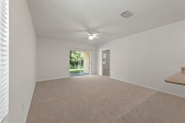 spare room with ceiling fan and carpet floors