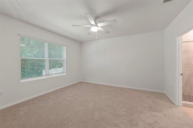 unfurnished room with ceiling fan and light colored carpet