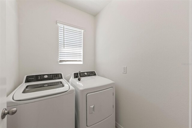 washroom featuring independent washer and dryer