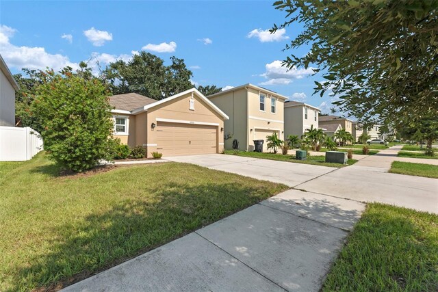 view of front of property featuring a front lawn and a garage