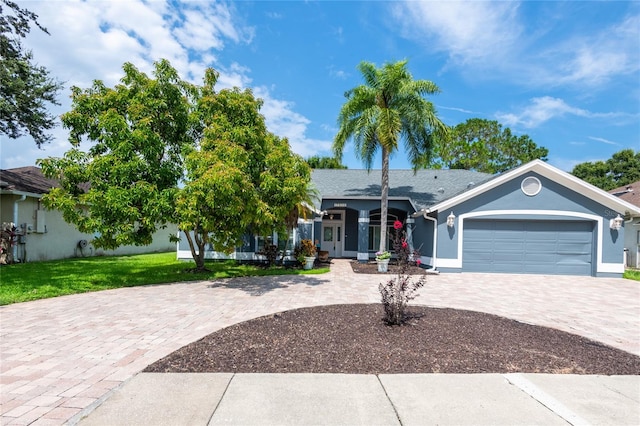 view of front of property featuring a front lawn and a garage