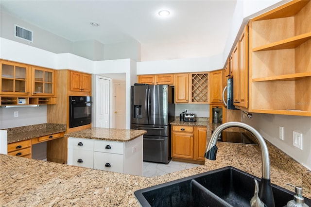 kitchen featuring light stone counters, sink, white cabinets, and stainless steel appliances