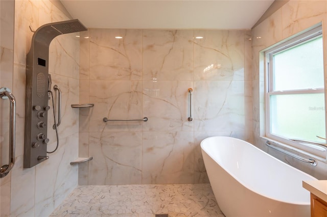 bathroom with vanity, separate shower and tub, and a wealth of natural light