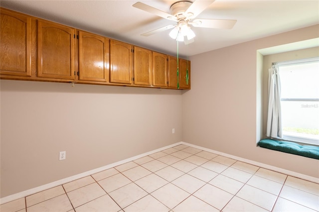 washroom with ceiling fan and light tile patterned floors