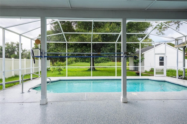 view of swimming pool with a lanai, a yard, and a patio