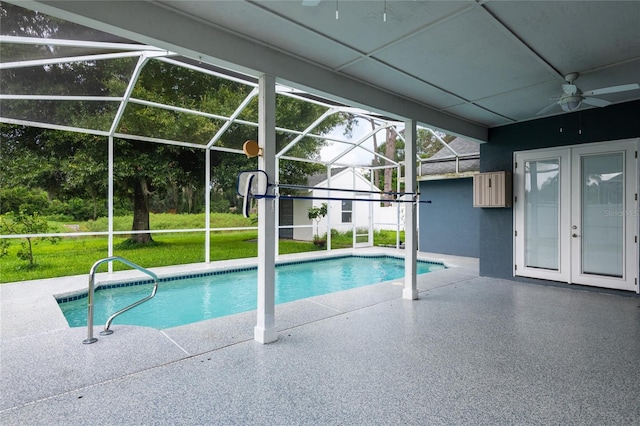 view of swimming pool featuring french doors, a patio, glass enclosure, and ceiling fan