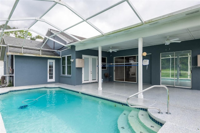 view of swimming pool featuring ceiling fan, a lanai, a patio, and french doors