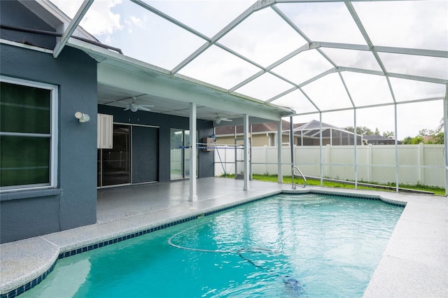 view of swimming pool with a patio area, ceiling fan, and a lanai