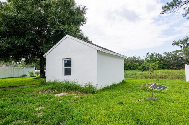 view of property exterior with an outbuilding and a yard