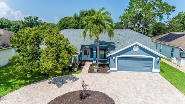 view of front of house with a front lawn and a garage