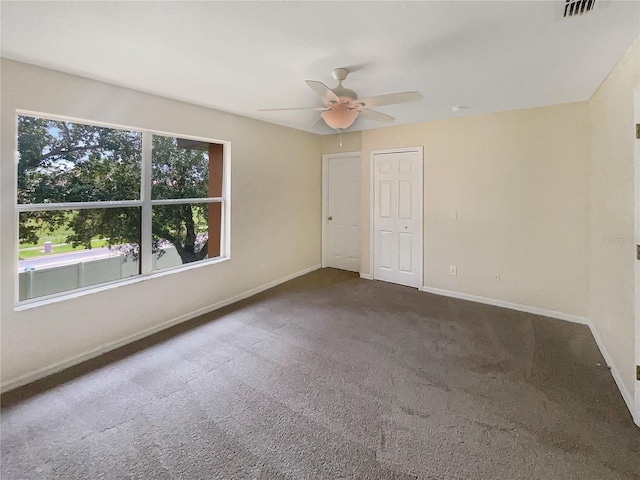 unfurnished bedroom with ceiling fan and carpet