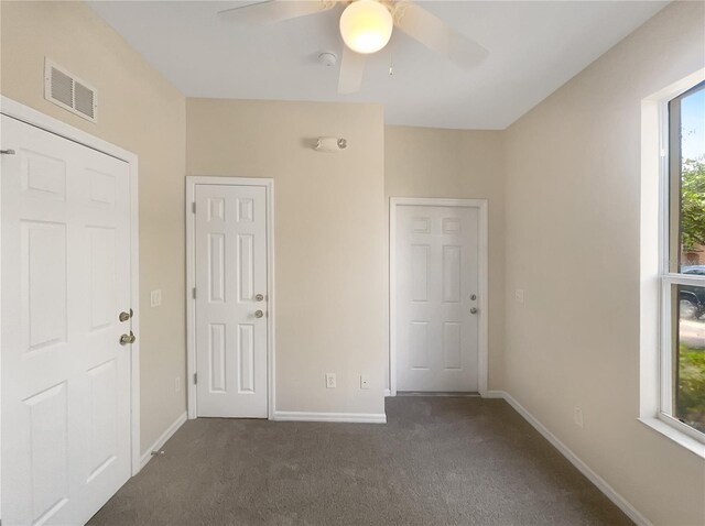 unfurnished bedroom with ceiling fan and carpet floors