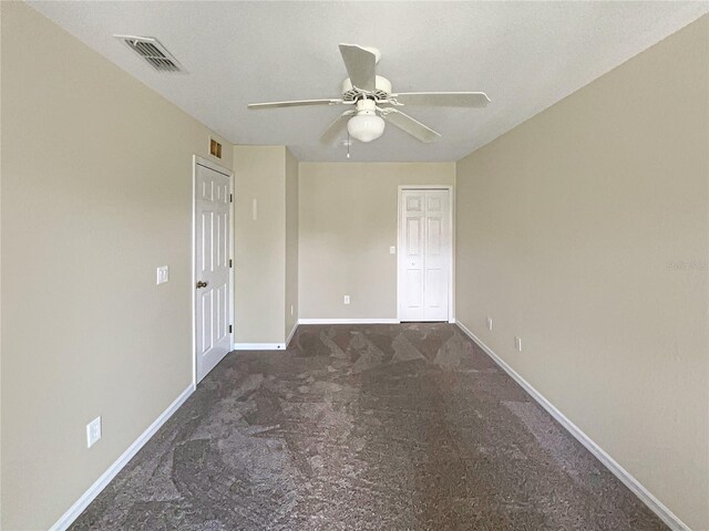 carpeted spare room with ceiling fan