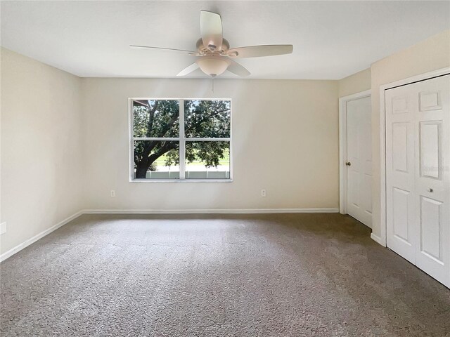 unfurnished bedroom with ceiling fan and carpet floors