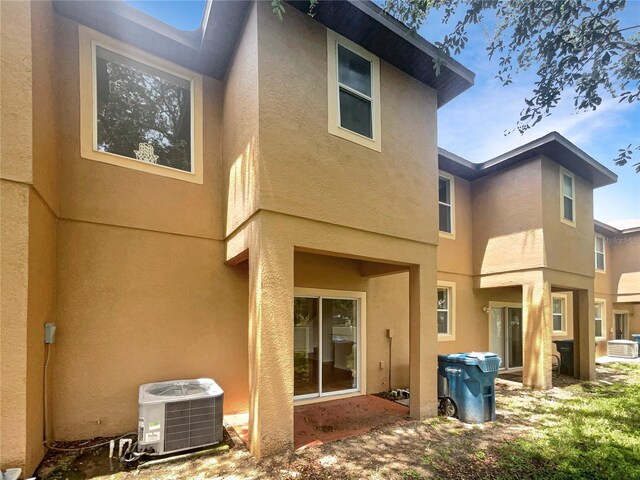 rear view of property featuring central air condition unit