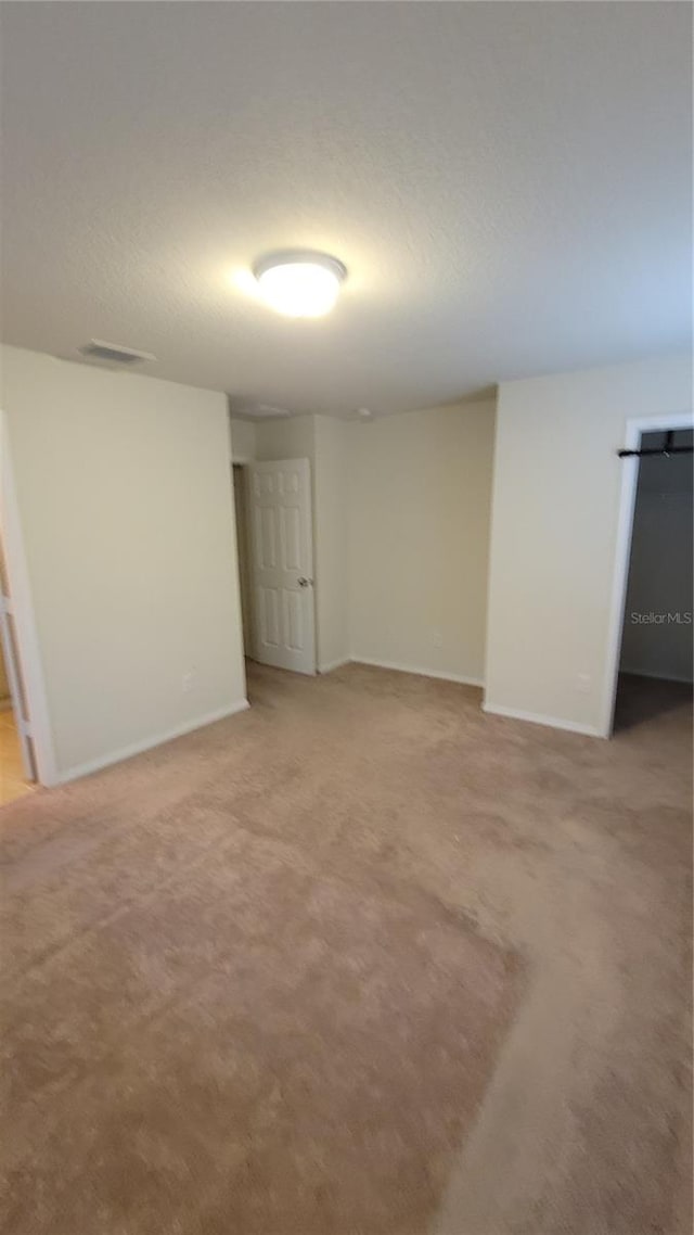 spare room with light colored carpet