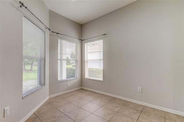 unfurnished room featuring light tile patterned floors