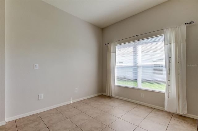 spare room with light tile patterned floors