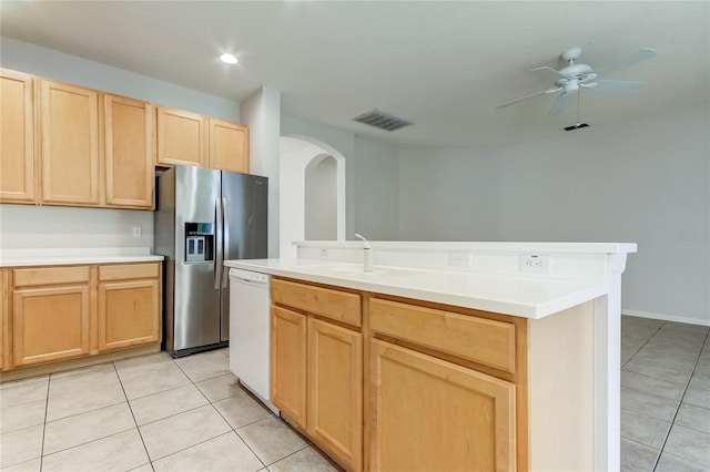 kitchen featuring white dishwasher, stainless steel fridge with ice dispenser, a center island with sink, light tile patterned floors, and sink