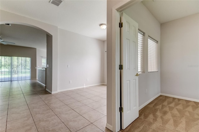 spare room with light tile patterned floors and ceiling fan