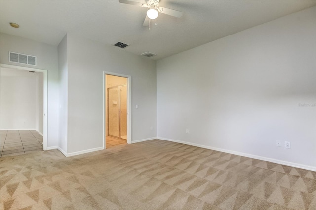 carpeted spare room featuring ceiling fan