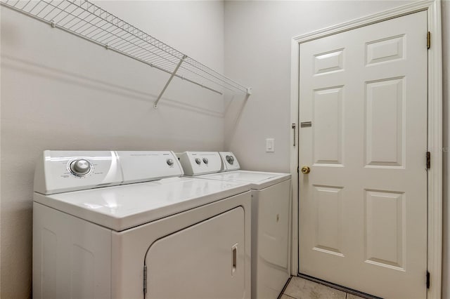 washroom with washing machine and dryer and light tile patterned flooring