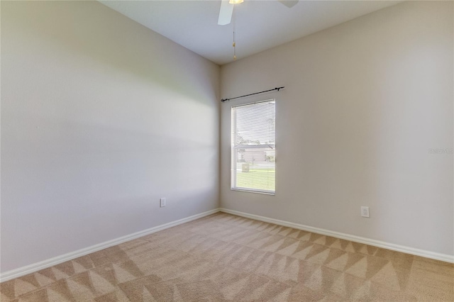 unfurnished room with ceiling fan and light carpet