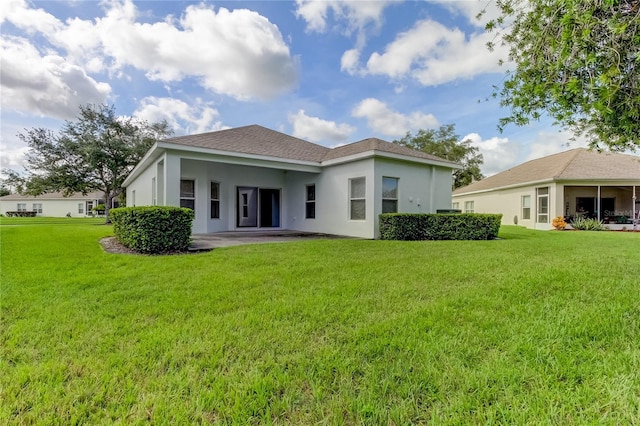 back of property featuring a yard