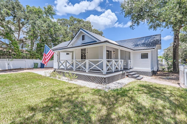 back of property with a porch and a yard