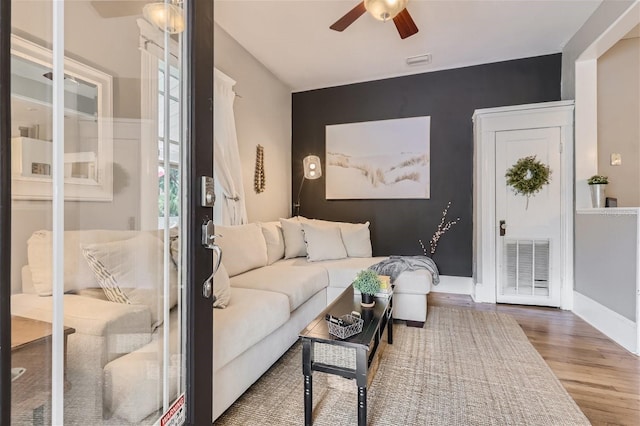 living room with ceiling fan and hardwood / wood-style flooring