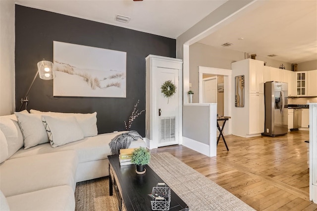 living room with light hardwood / wood-style flooring