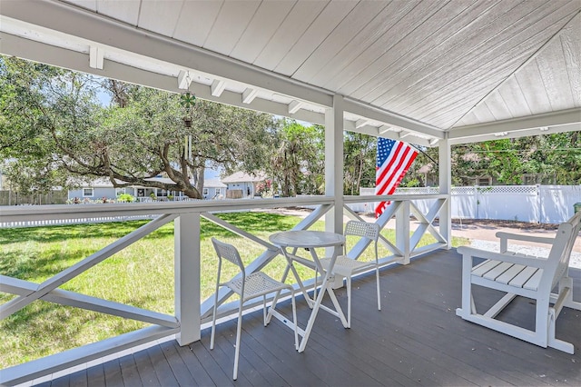 wooden terrace featuring a yard