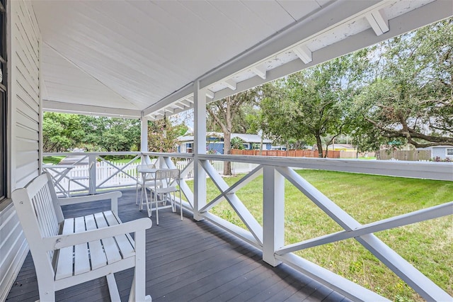 sunroom / solarium featuring vaulted ceiling