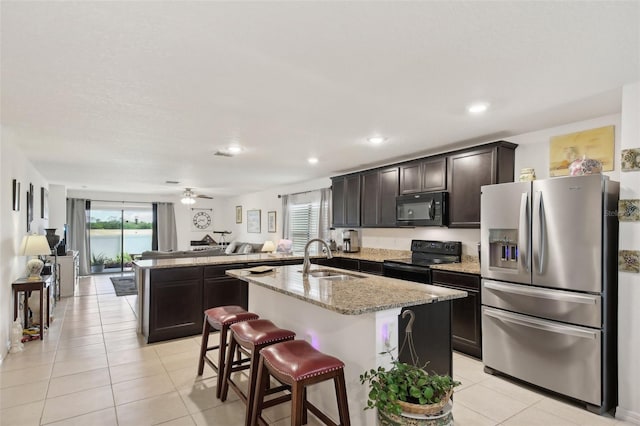 kitchen with sink, ceiling fan, a center island with sink, and black appliances