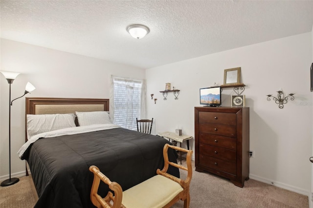 carpeted bedroom featuring a textured ceiling