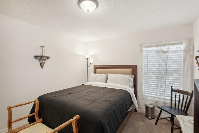 bedroom featuring a textured ceiling and carpet floors